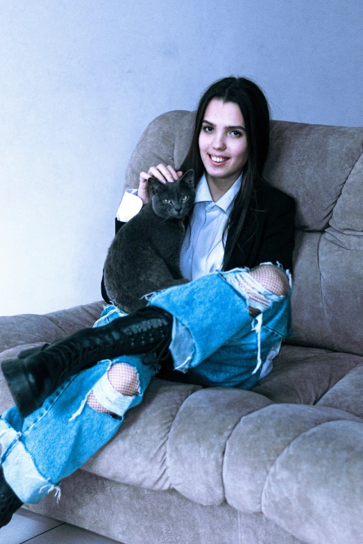 a woman sitting on a couch with a cat