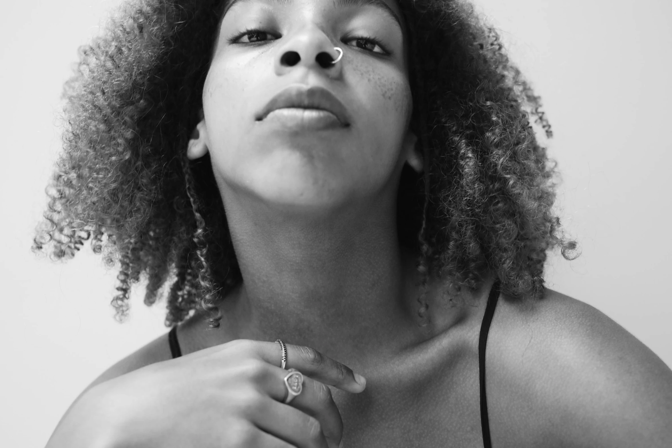 a black and white po of a woman's head with curly hair