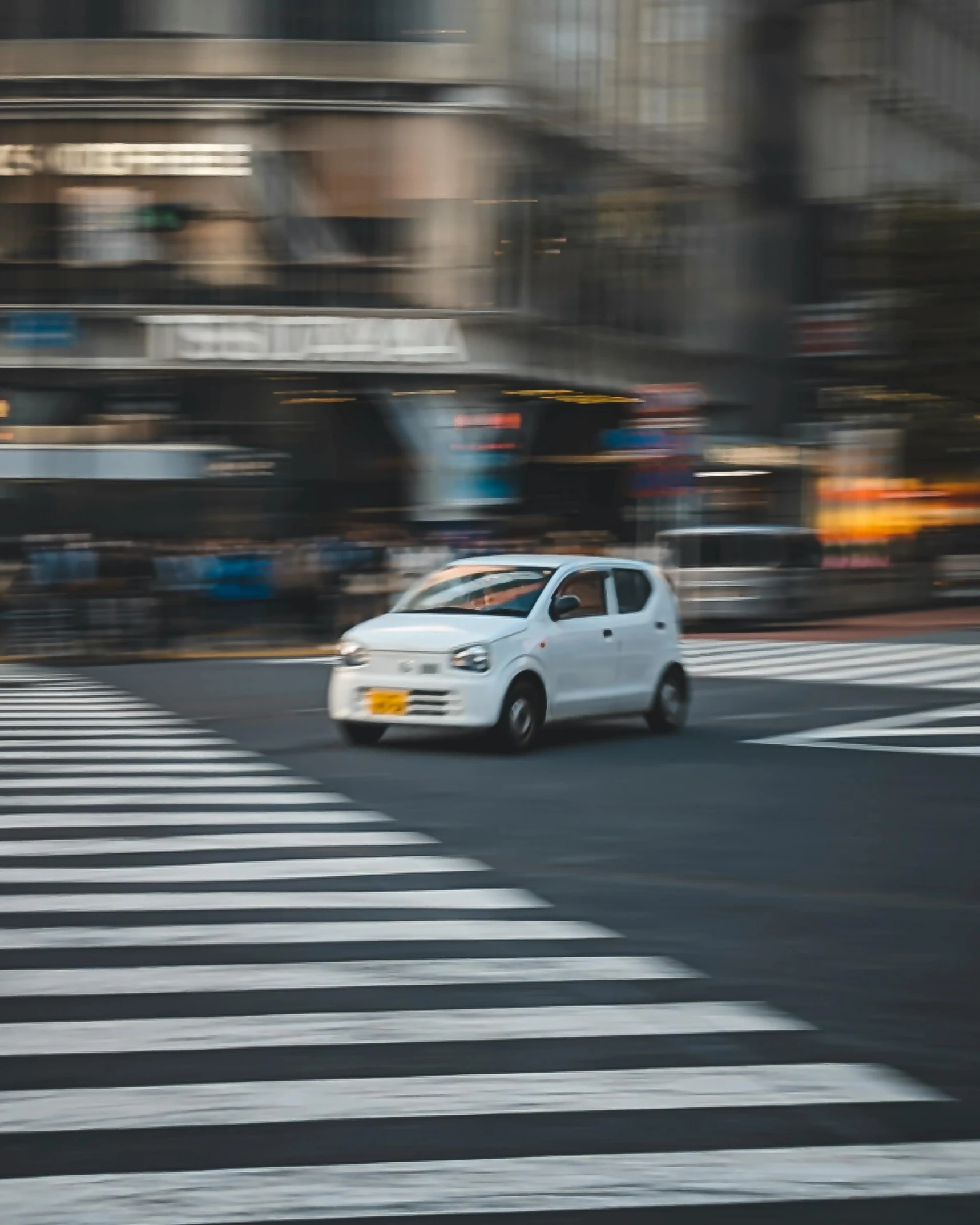 there is a white car in a city with buildings