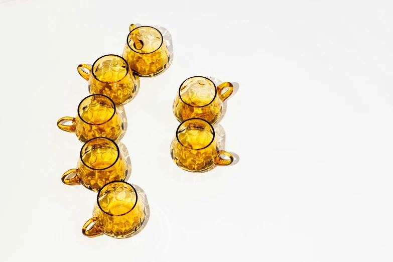 several glass cups sitting on top of a white table