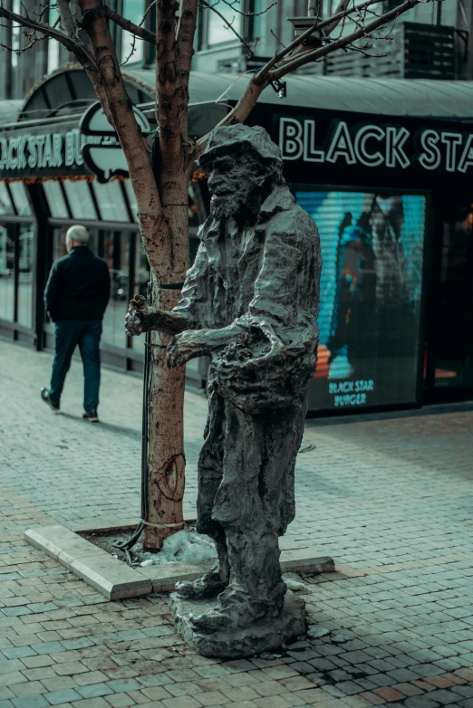 a statue is posed on the street corner