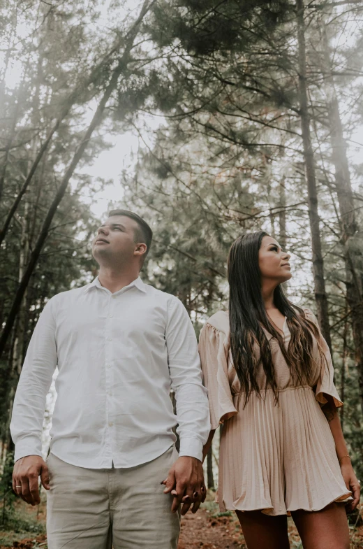 man standing next to woman on the forest