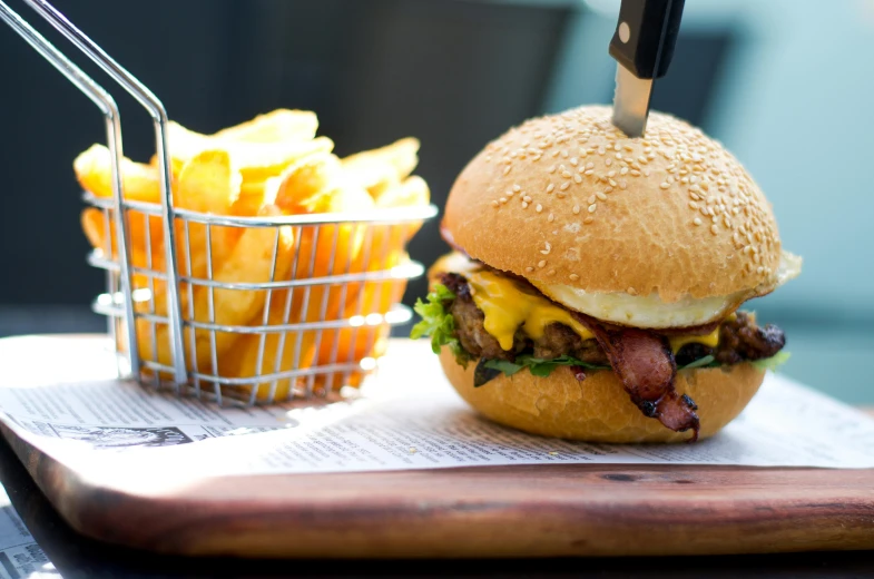 there is a burger and basket of fries on the counter