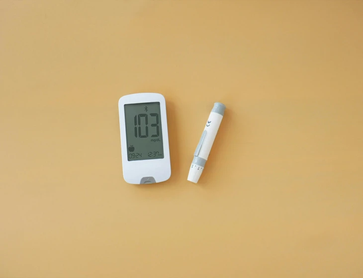 a digital thermometer is shown next to a pen