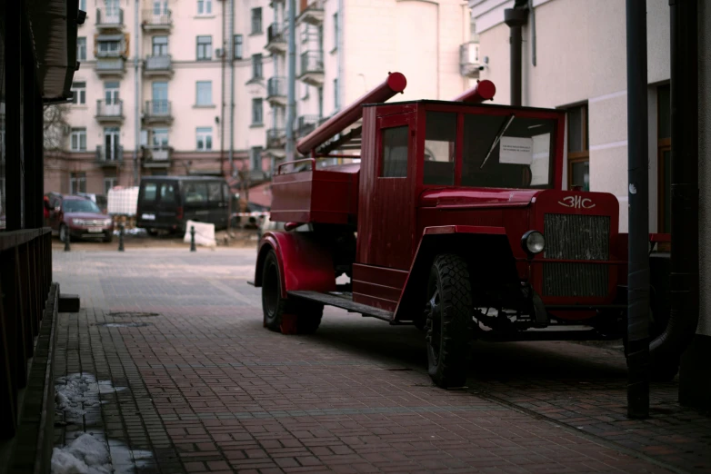 old pick up truck in city setting on cobblestone