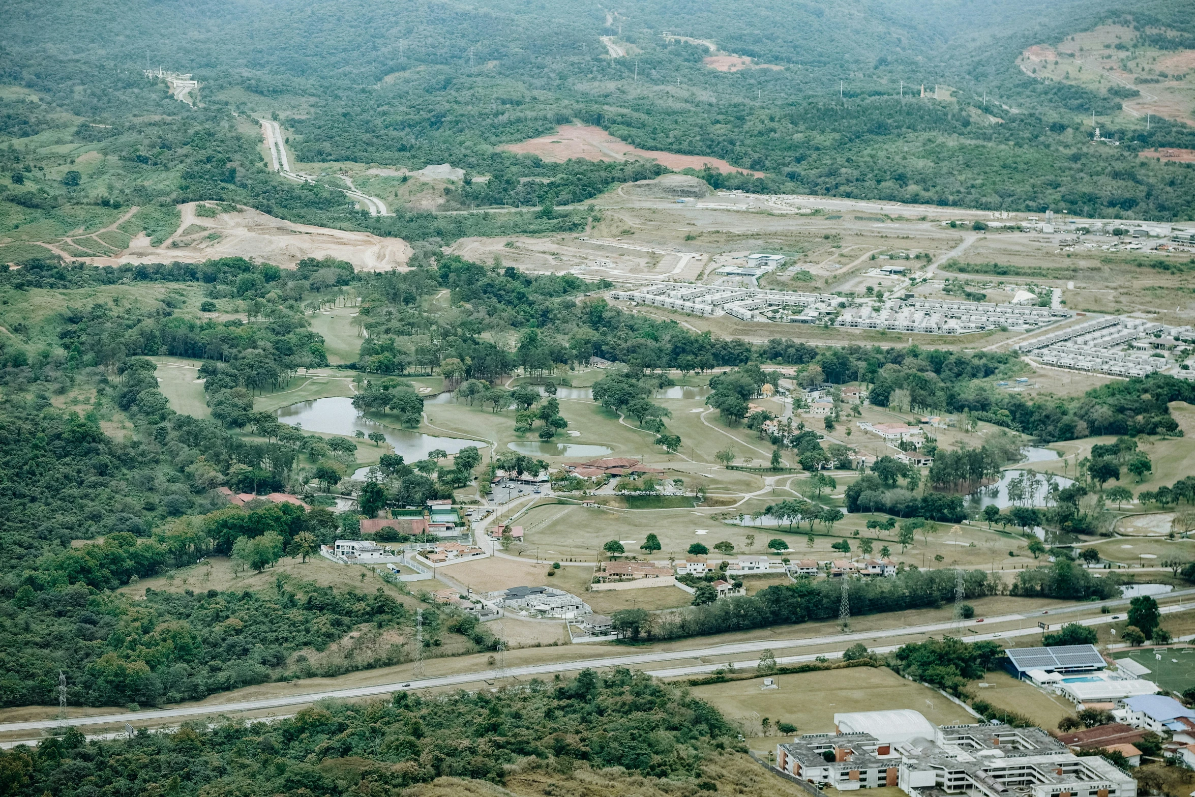 a small area of land with various buildings and trees in it