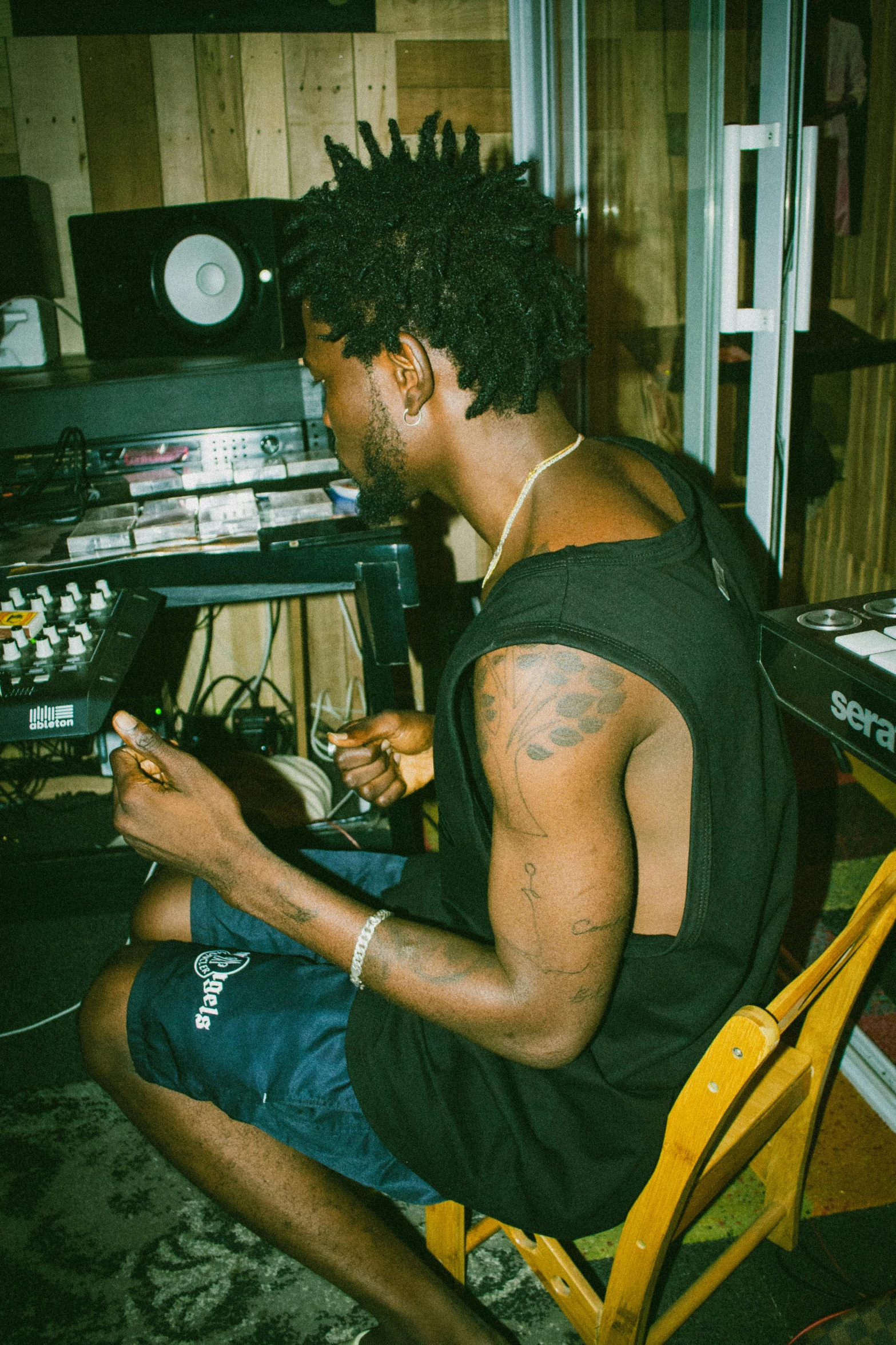 a young man sitting in a chair holding a cell phone