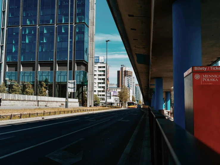 there is a empty road and a building near it