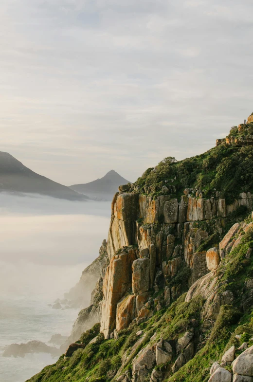 a hillside that is surrounded by rocks and water