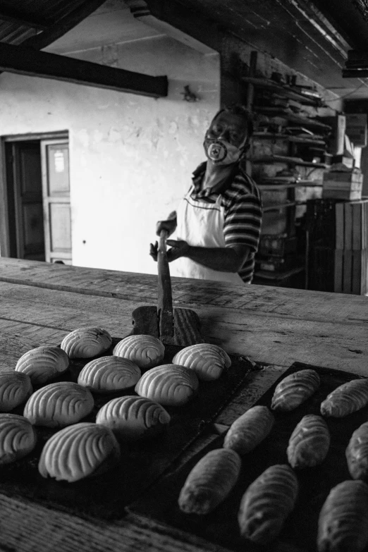 a man working in an antique shop for bread