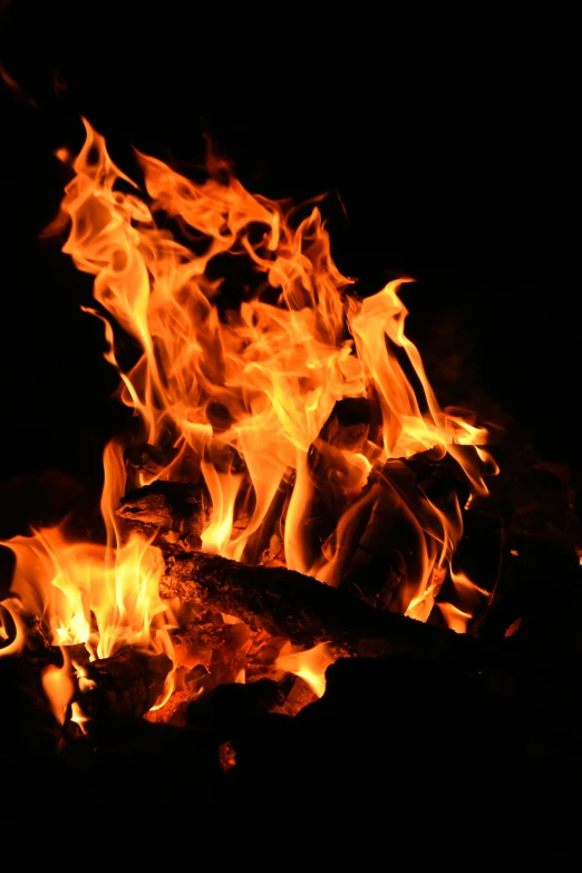 a close - up po of a fire showing orange, yellow and red flames