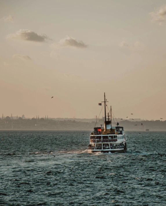 a ferry with people travelling across a large body of water