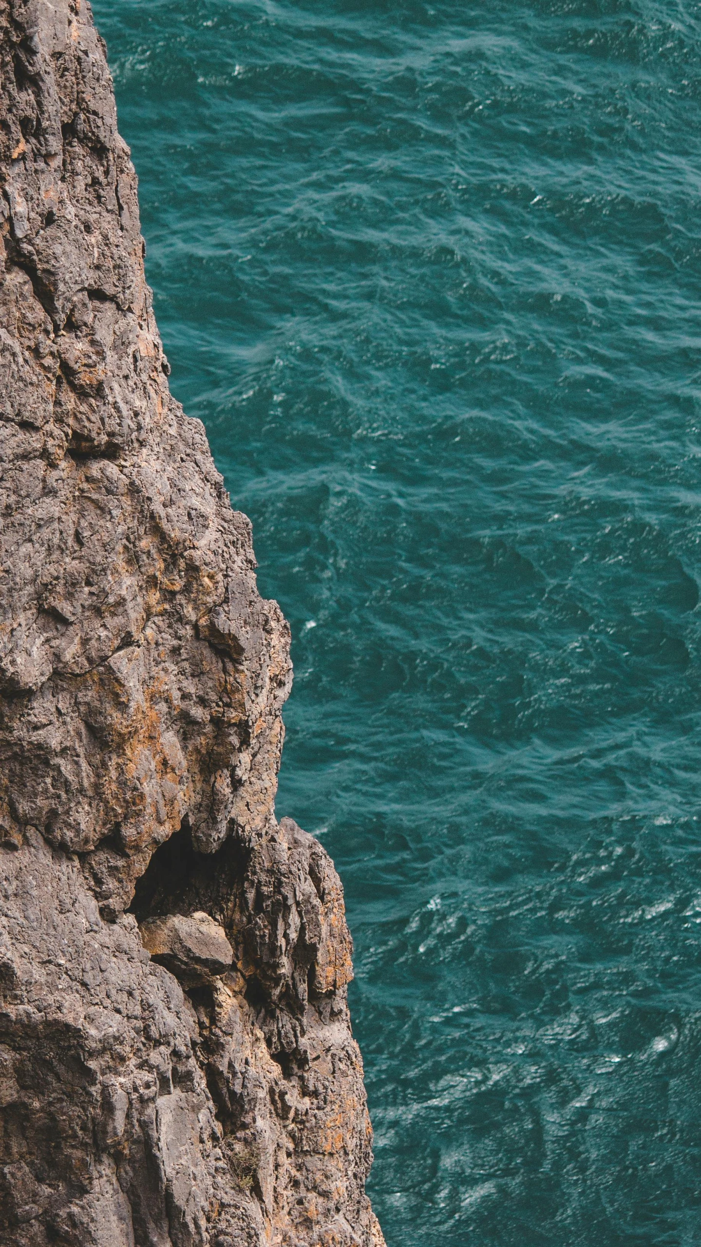 the person is watching the boat go down the ocean