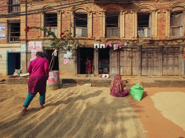 a large pile of sand and dirt is in front of a building