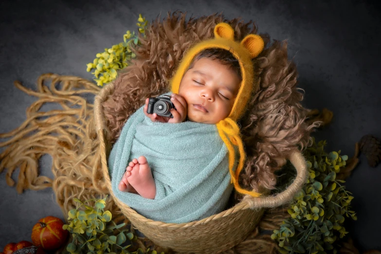 a baby sleeps in a basket with a camera on his head