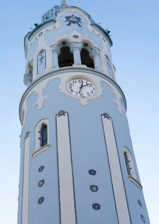 a clock tower that is white and blue