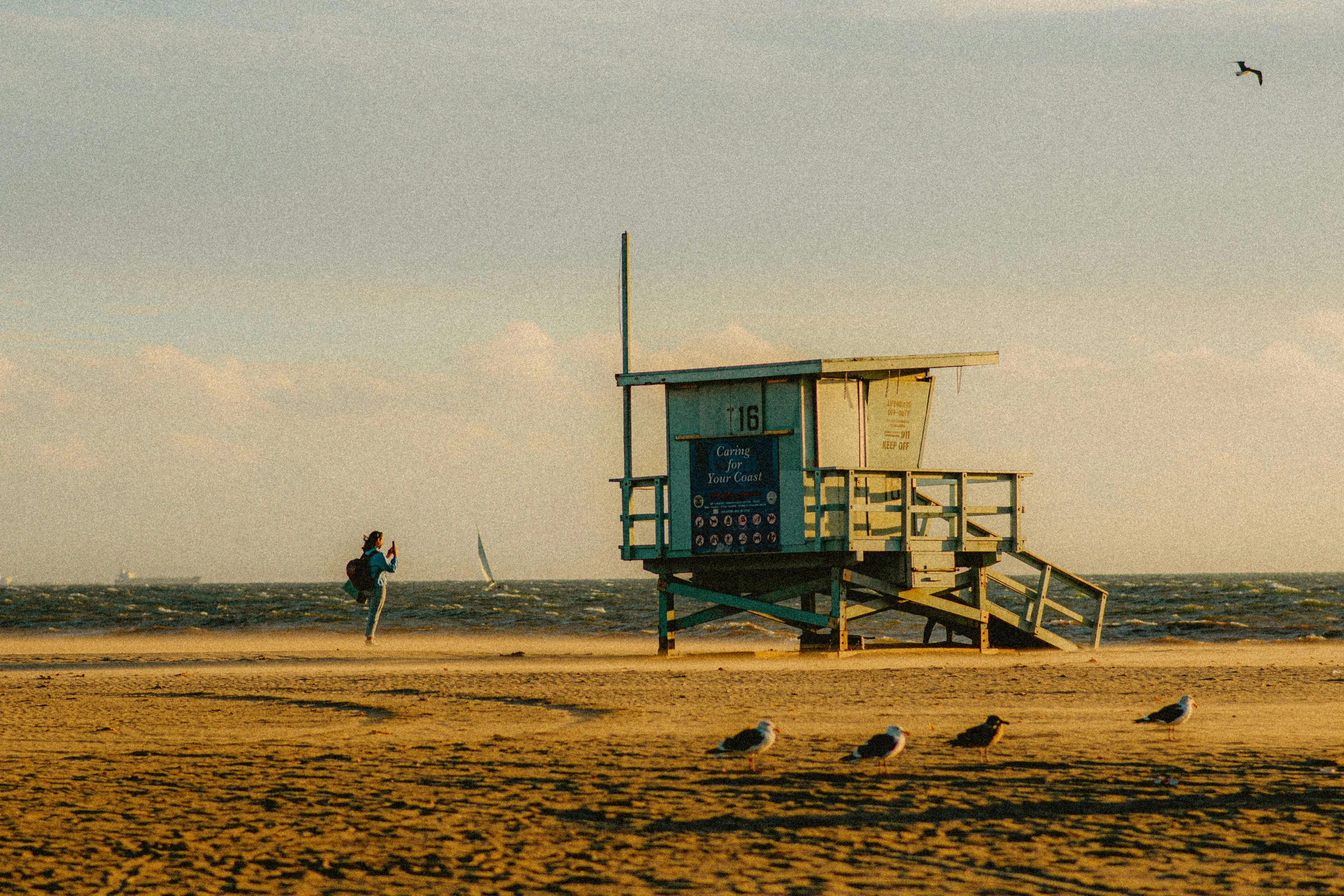 two people walking towards a lifeguard tower