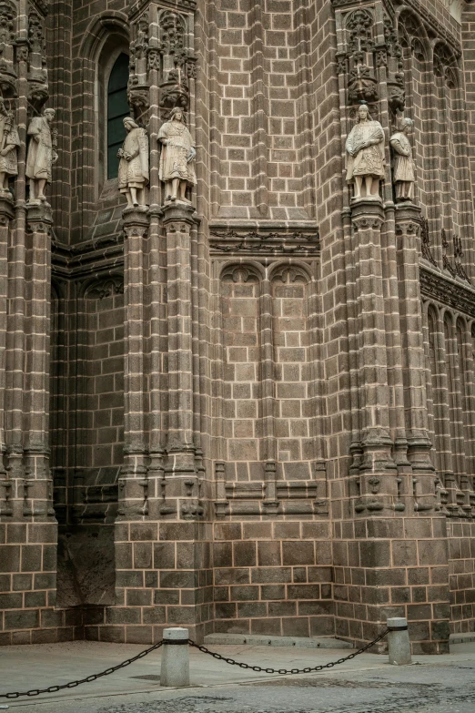 an old stone building has statues on the front