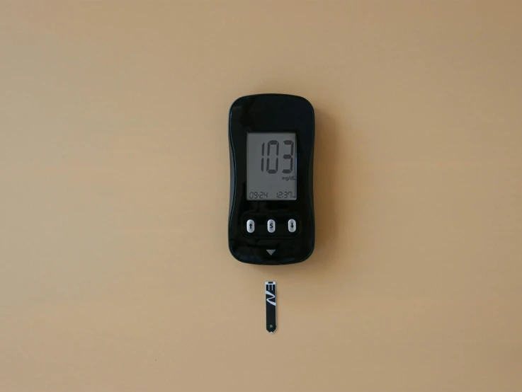 a digital clock set on the wall and hanging off