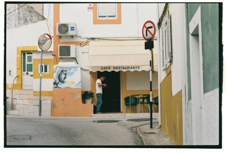 a man is in an empty alley and looks at a building