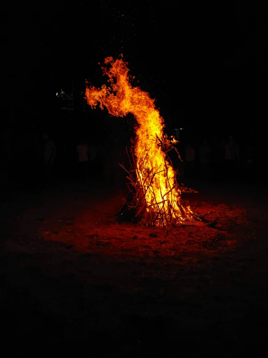 a big open fire pit full of bright yellow smoke