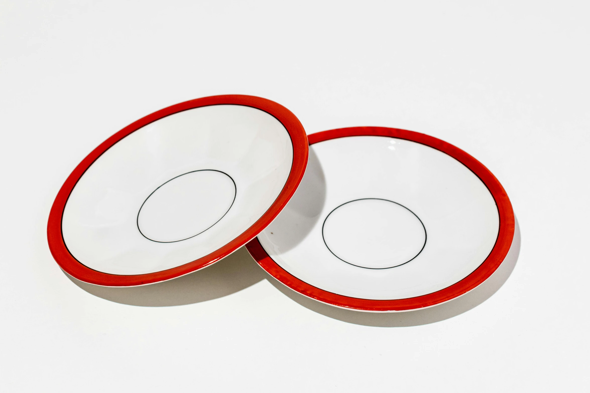 two bowls are sitting on a white surface