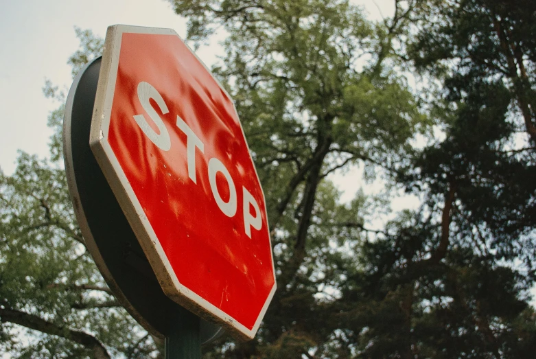 a stop sign that is attached to a pole