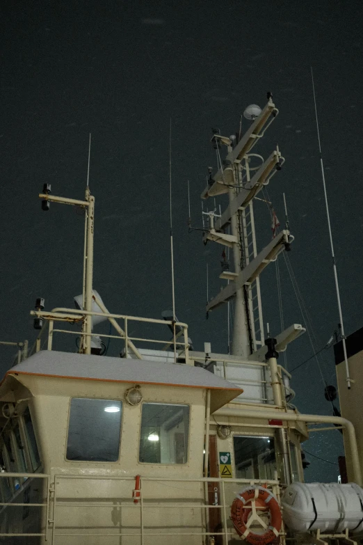 the front of a boat docked at the dock at night