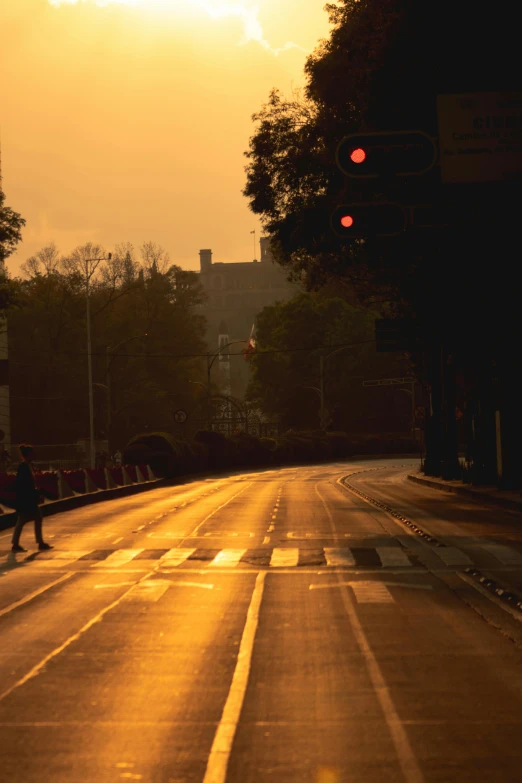 a person is crossing the street in front of a traffic light