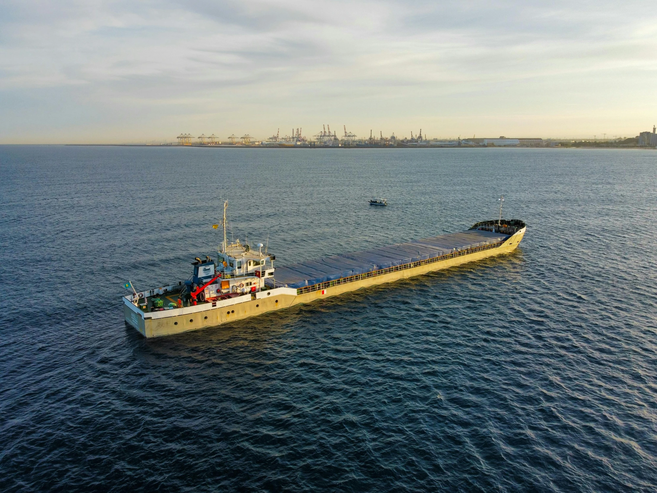 a barge with a long floating cargo dock in the middle of water