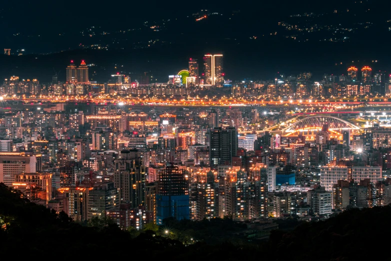 a city lit up at night in a large open area
