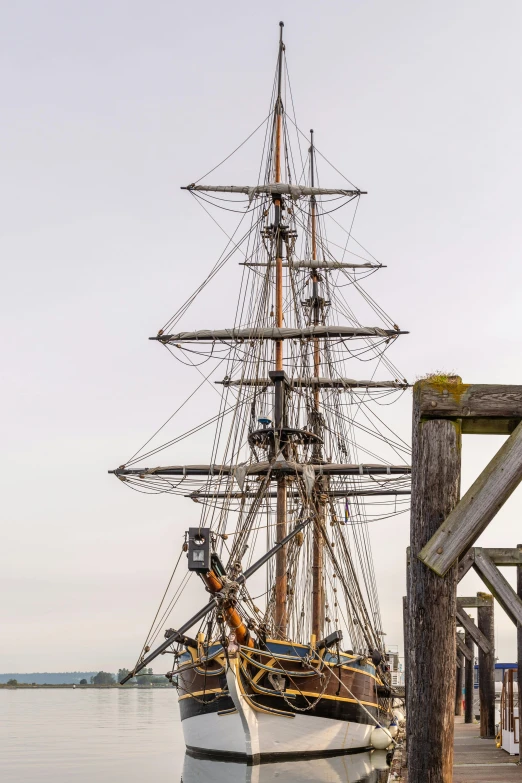 a tall boat is docked on the dock