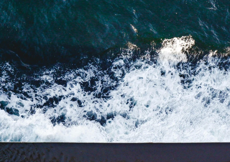 water from the top of a surfer who is on a wave