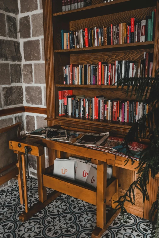 a wooden bench sitting in front of a book shelf