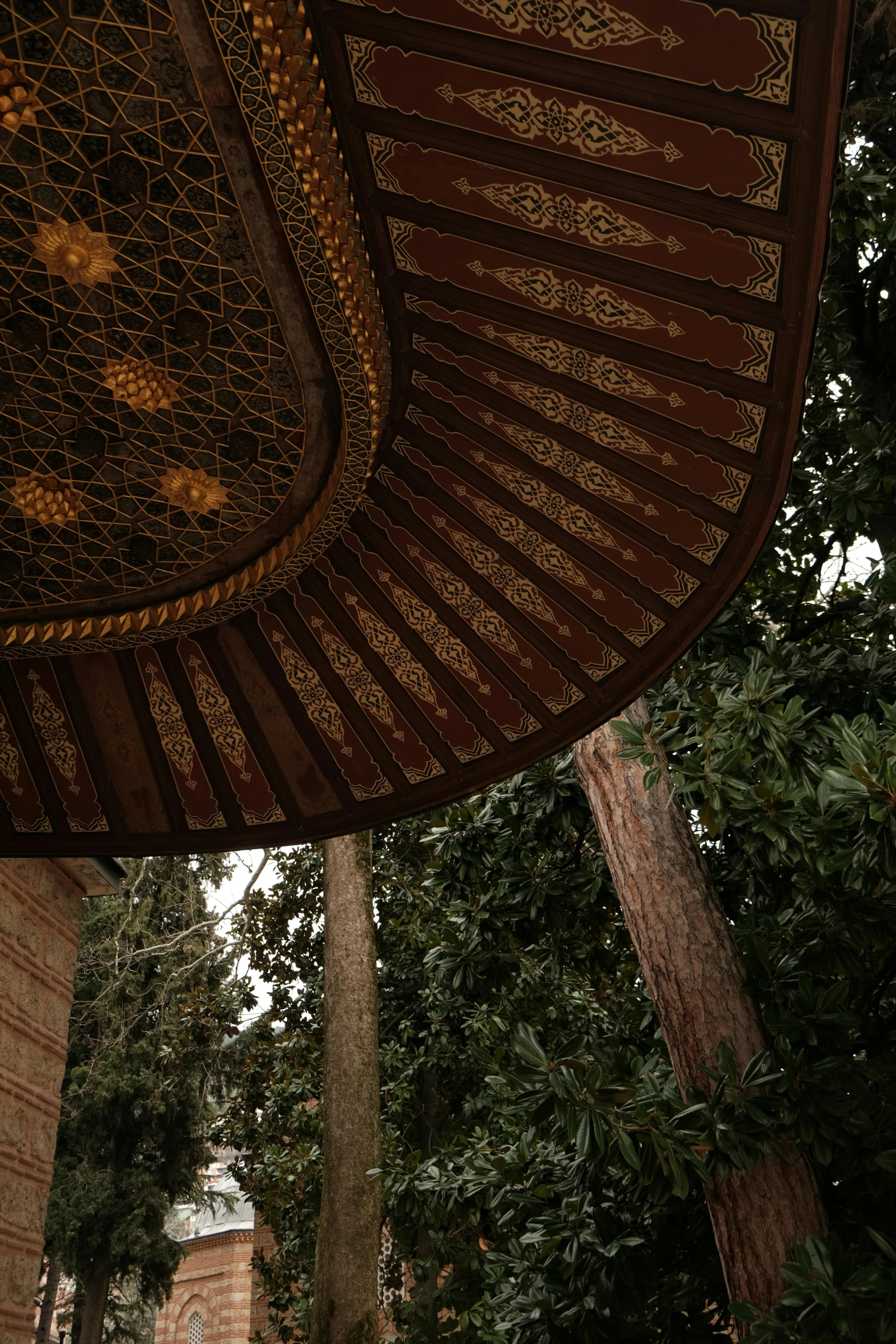 a brown ceiling in front of trees and a building