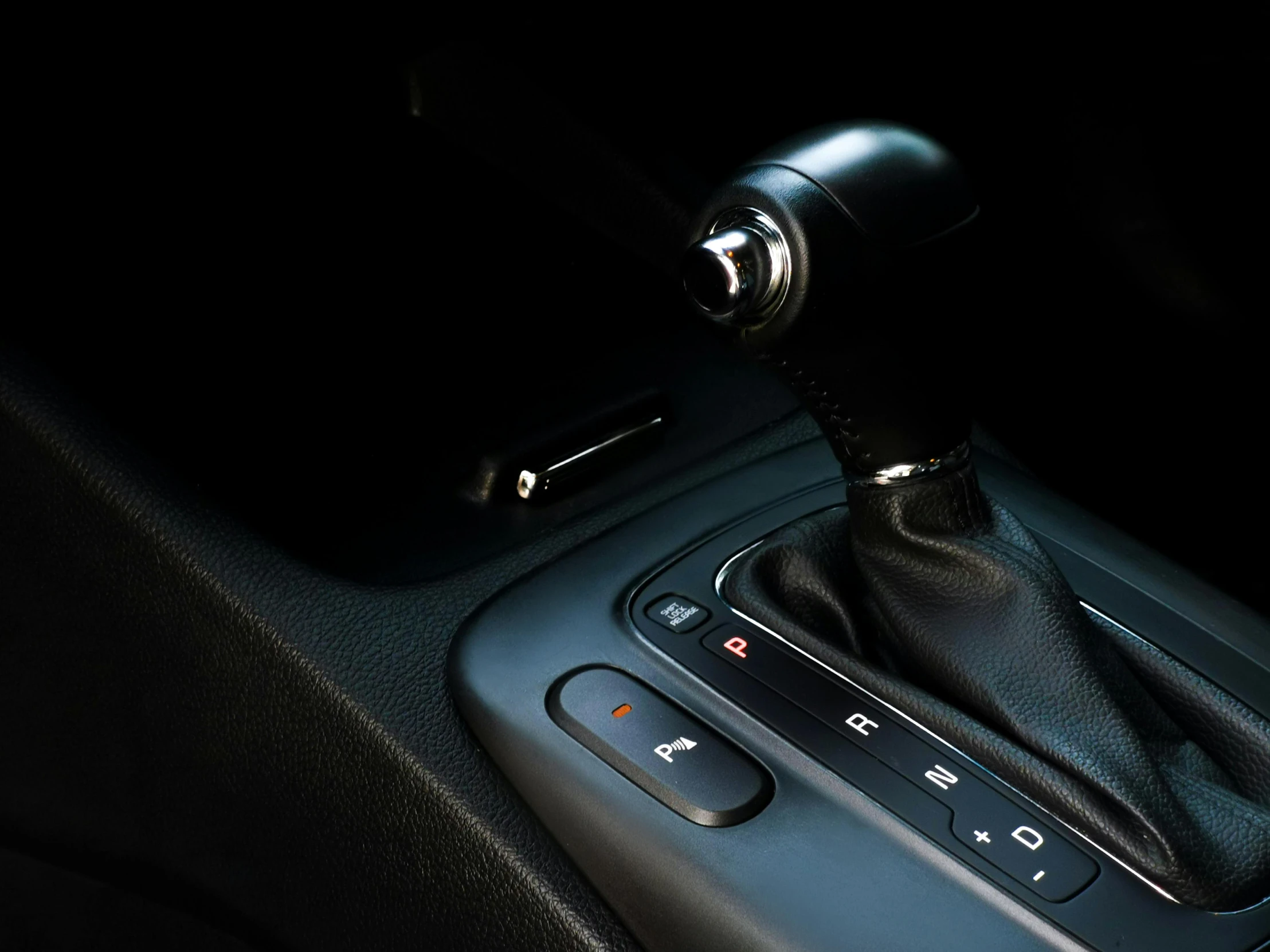 the interior view of an automatic car with a gear lever