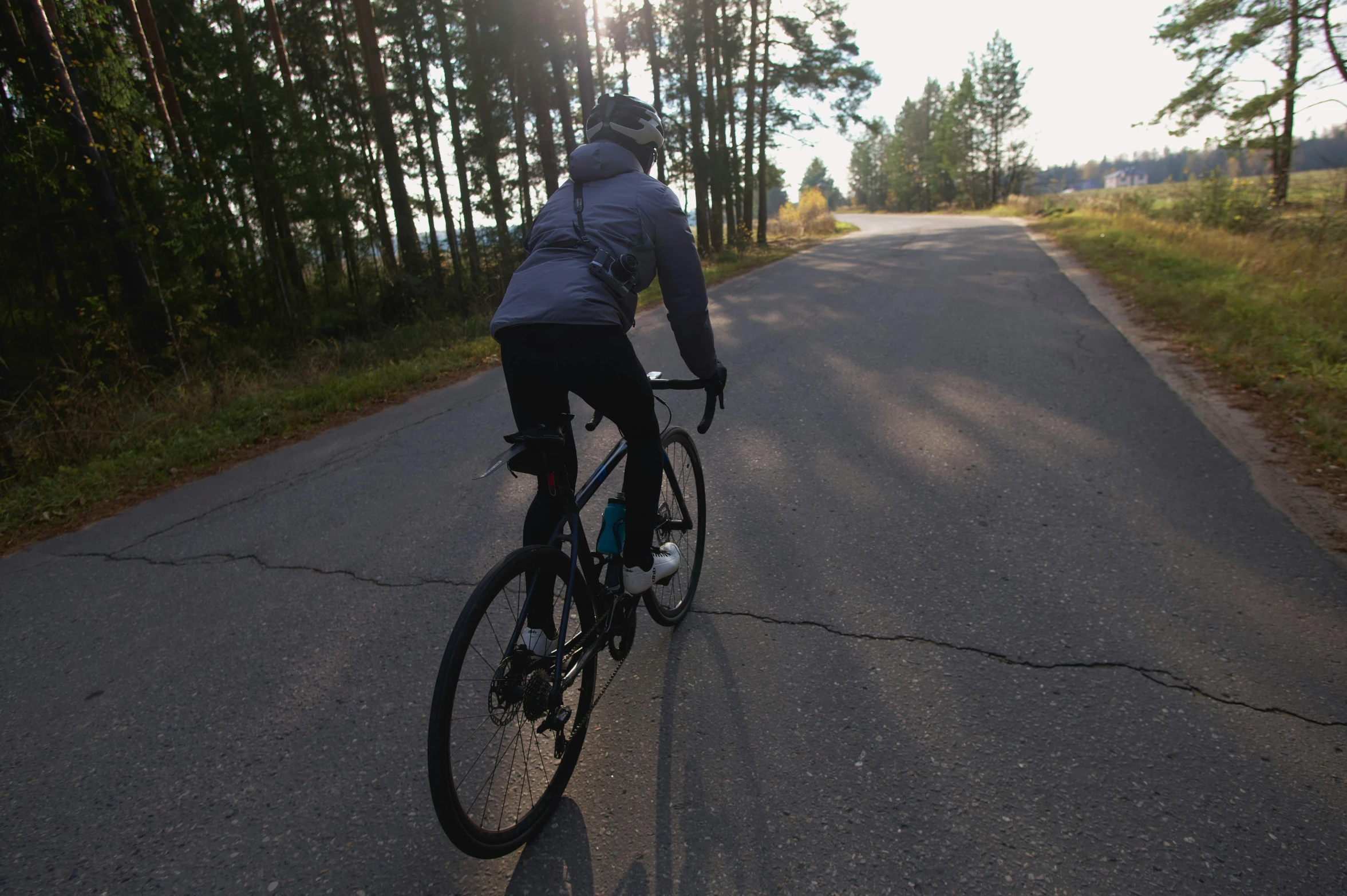 the person is riding his bicycle on the road