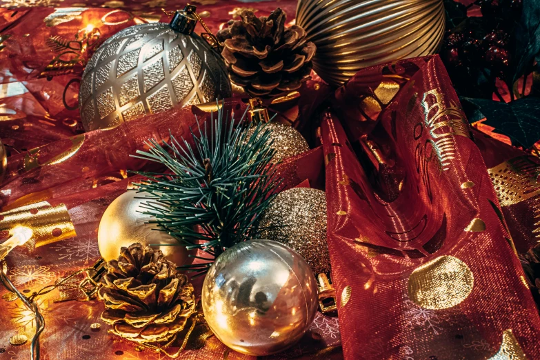 a red and gold christmas table cloth with many ornaments