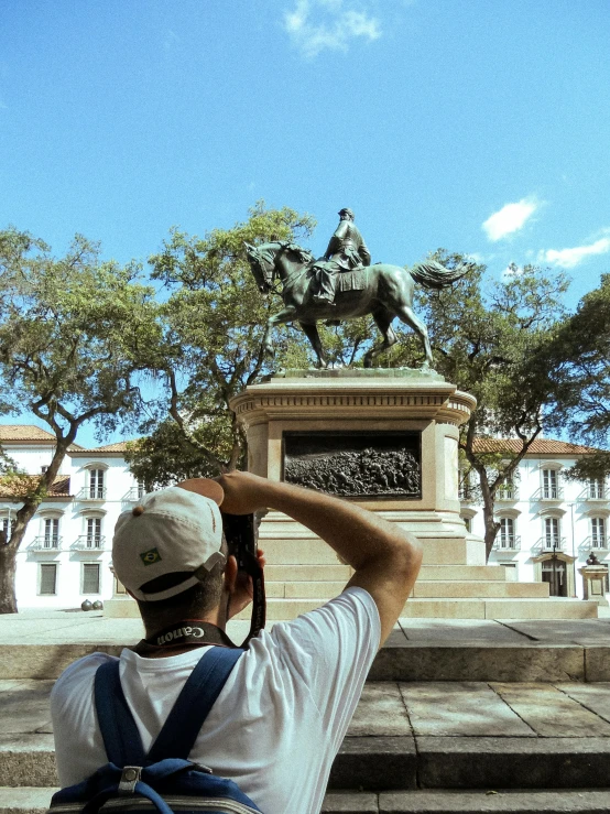 man taking pos of a statue on the steps