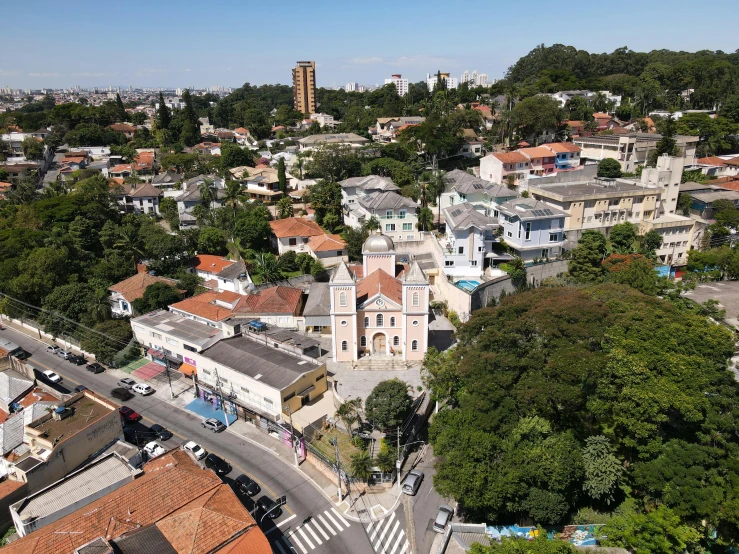 a view from the tower looking down on buildings in the foreground and trees