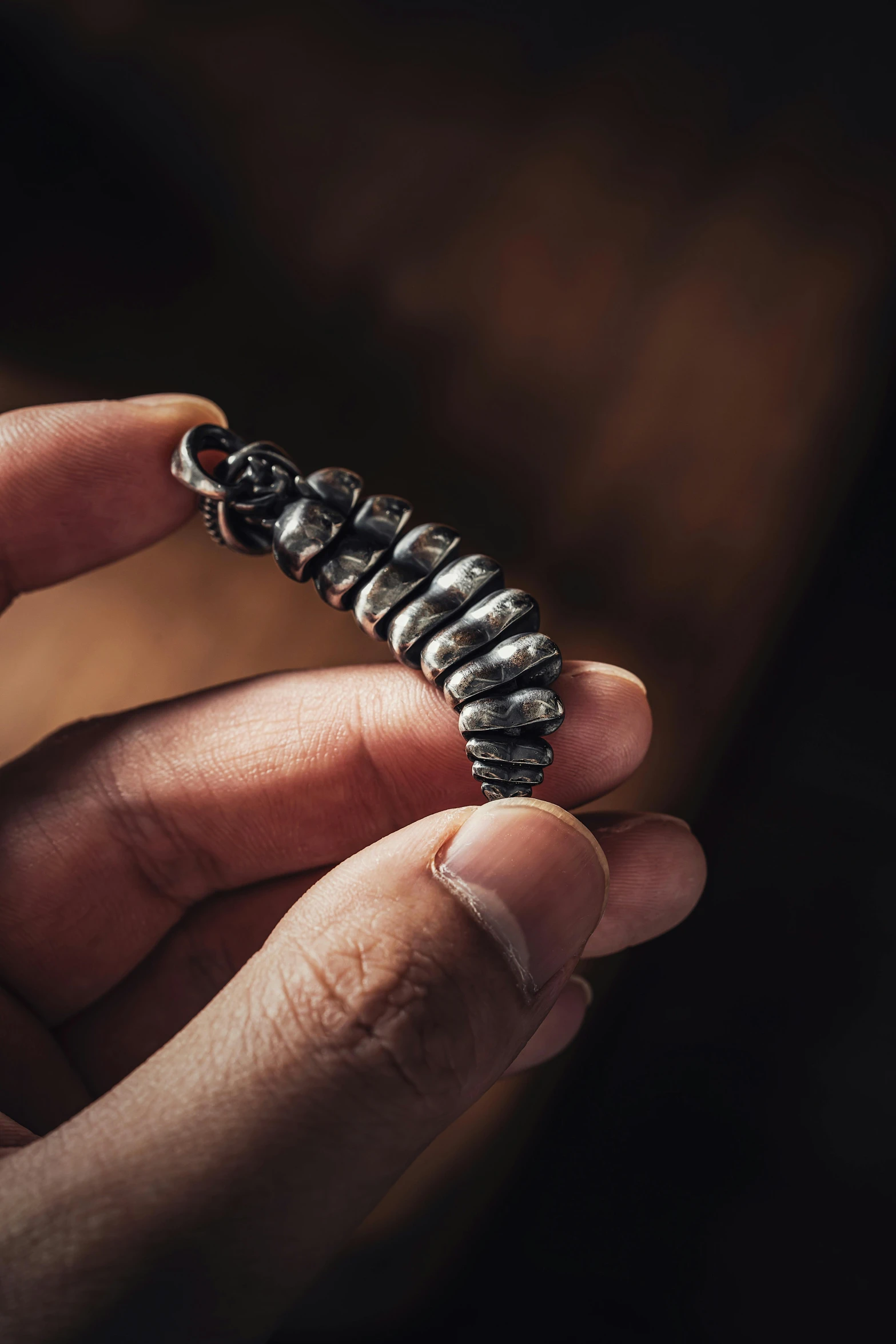 a tiny erfly caterpillar in someone's left hand