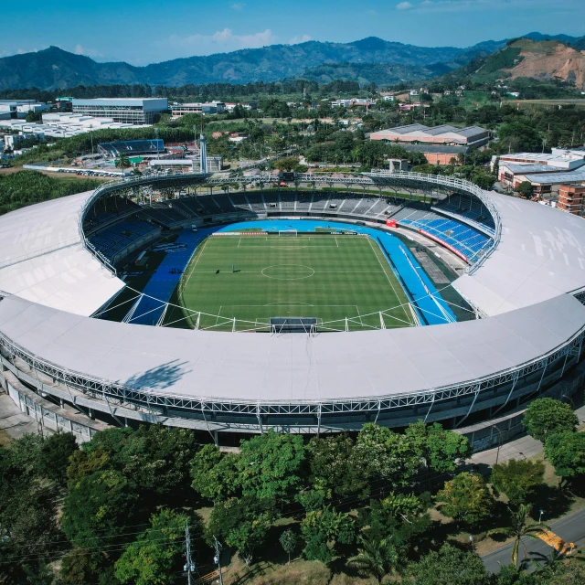 the large sports arena is next to mountains