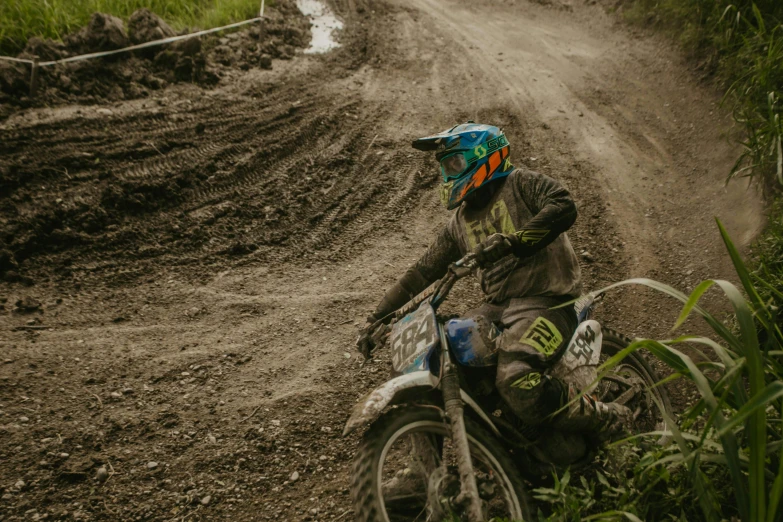 a dirt bike rider on dirt road in rural area