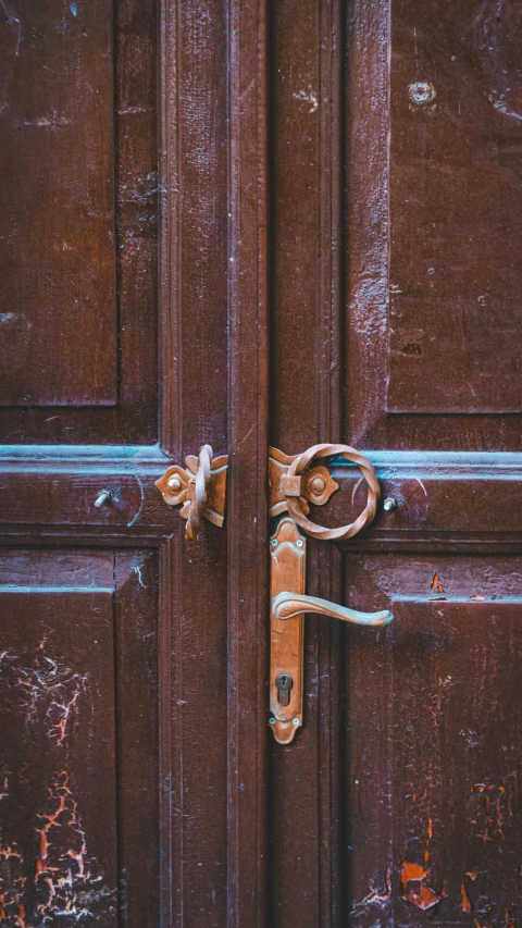 close up of a brown door handle and a lock