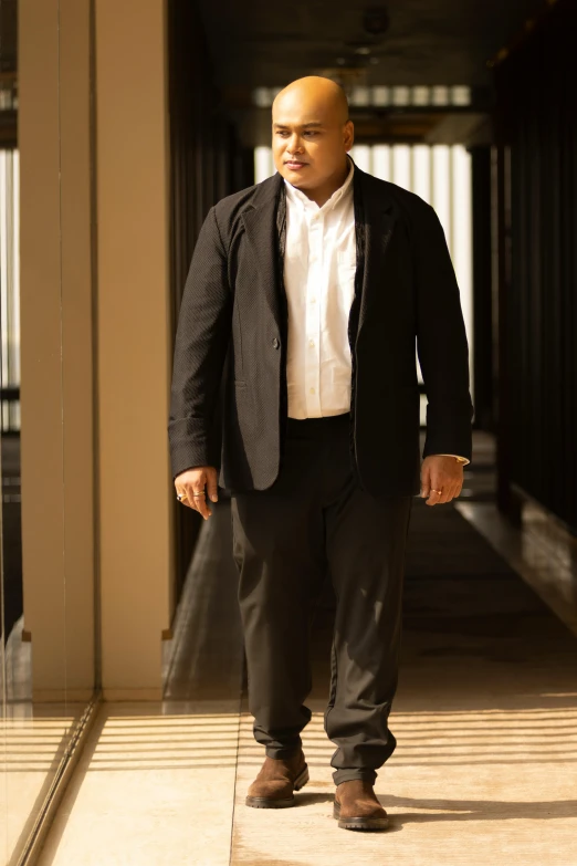 a young man standing alone in an empty building