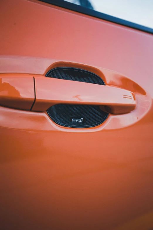 the door handle on an orange car