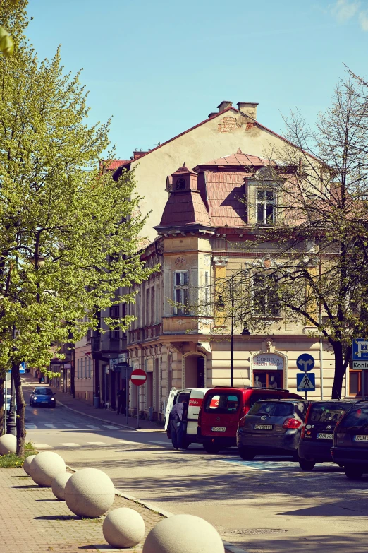 a street with various vehicles parked next to it