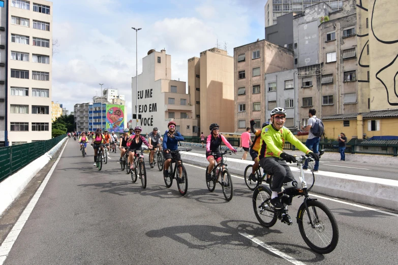 a bunch of bicyclists going down the street