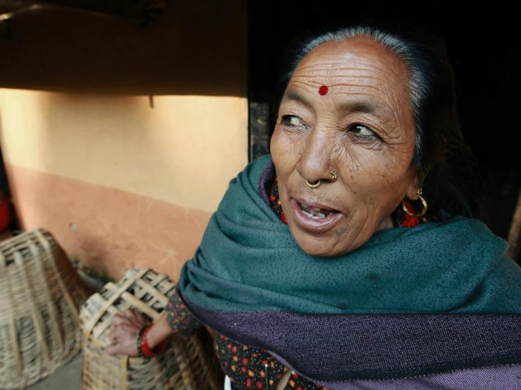 a woman with piercings on her nose looks at the camera