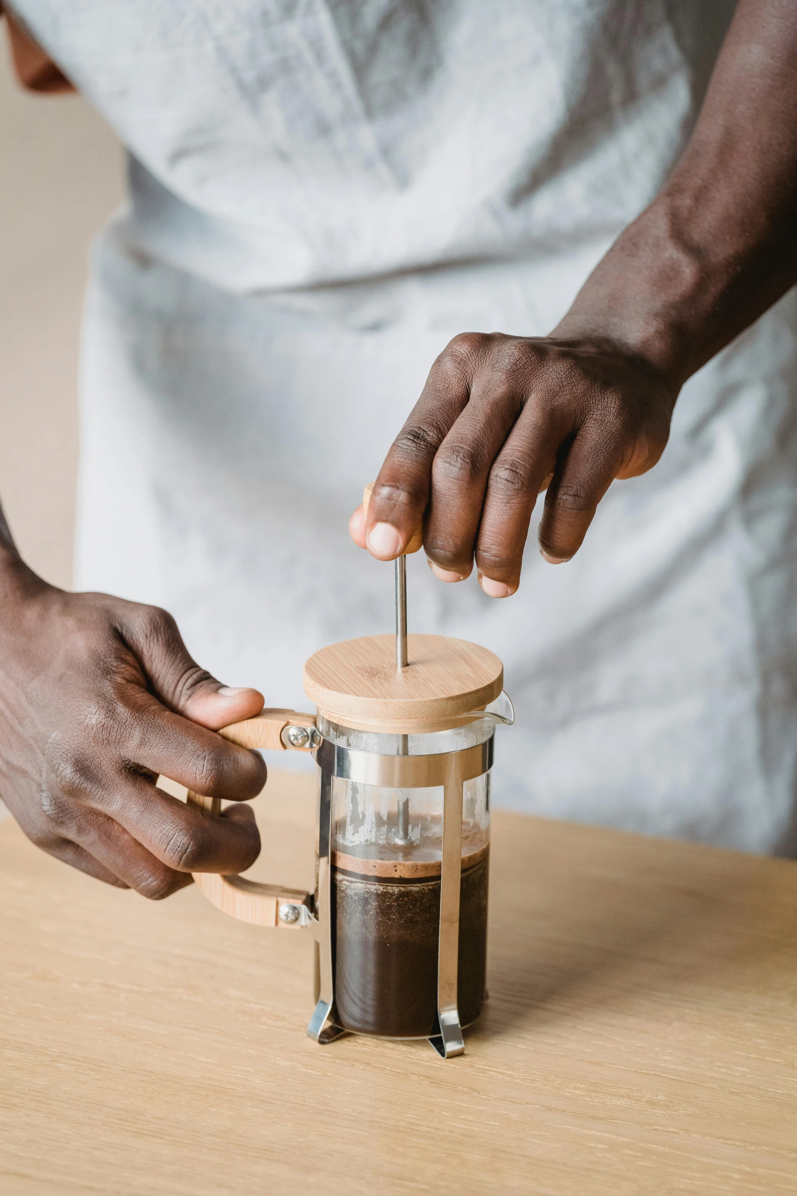 person turning the blade on a coffee grinder